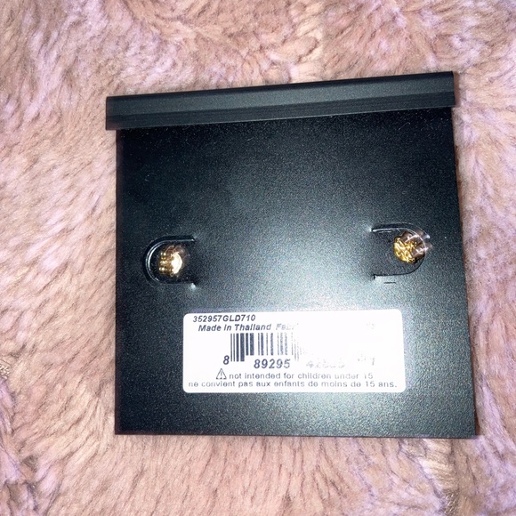Coach stud earrings never worn with a bag that has a makeup spot on it. - Picture 2 of 3